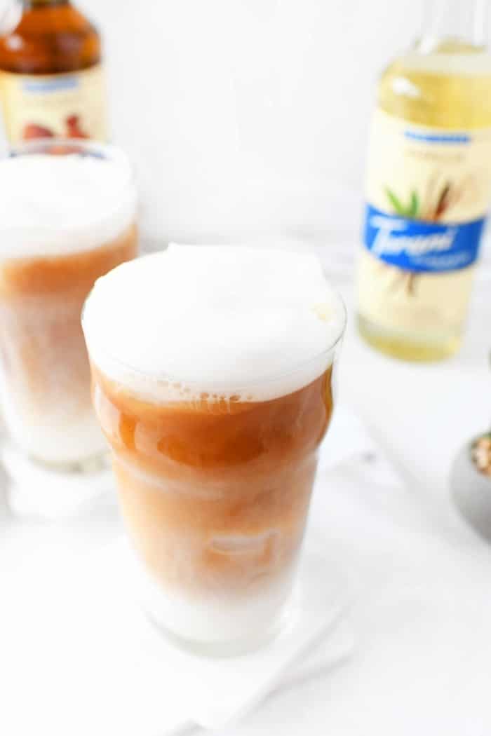 Ice Tea Latte with lots of white foam on top. 
