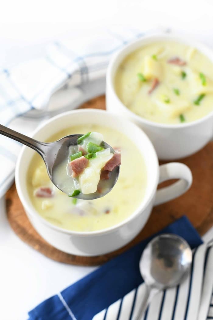 Potato and Ham soup in silver spoon. 