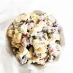 Chicken Salad with Grapes and walnuts in a white dish with a white napkin.