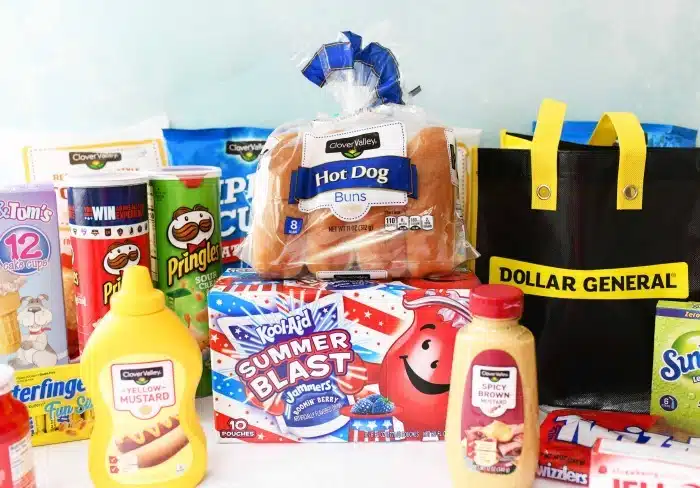 Dollar General Groceries on white table with yellow shopping bag. 