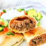 Beef Chimichangas opened up on white plate.