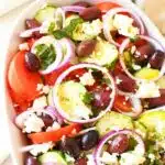 Greek Salad with Cucumber in white oval dish.