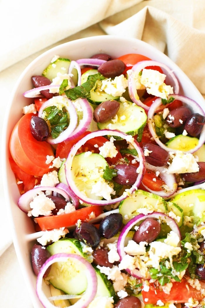 Greek Salad with Cucumber in white oval dish.