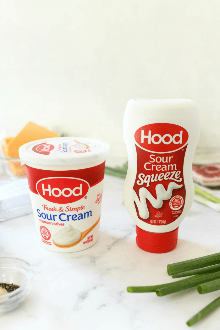 Hood sour cream bottles on table with ingredients.