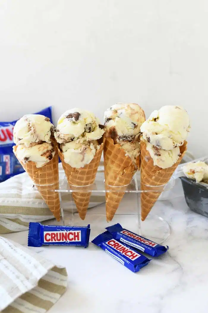 Crunch ice cream cones in a container with napkin.
