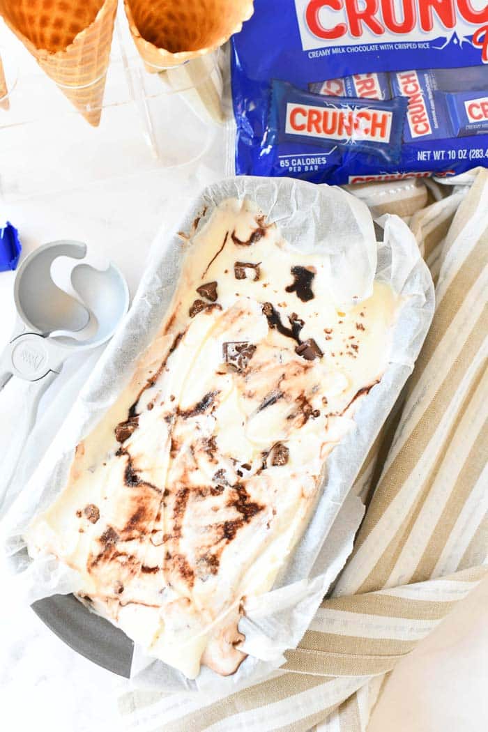 Homemade ice cream with candy bars frozen in a loaf pan.