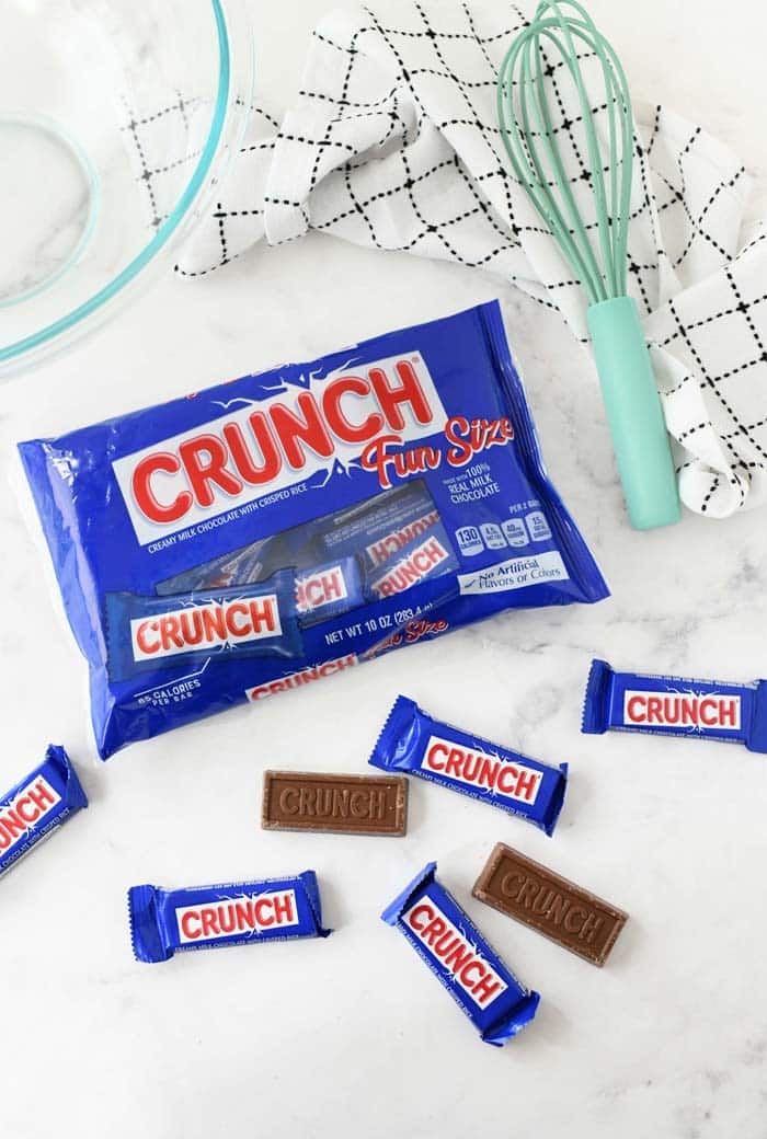 Nestle Crunch fun size bag with bars spread on table.