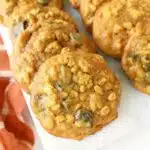 Pumpkin oatmeal cookies on a white tray up close.