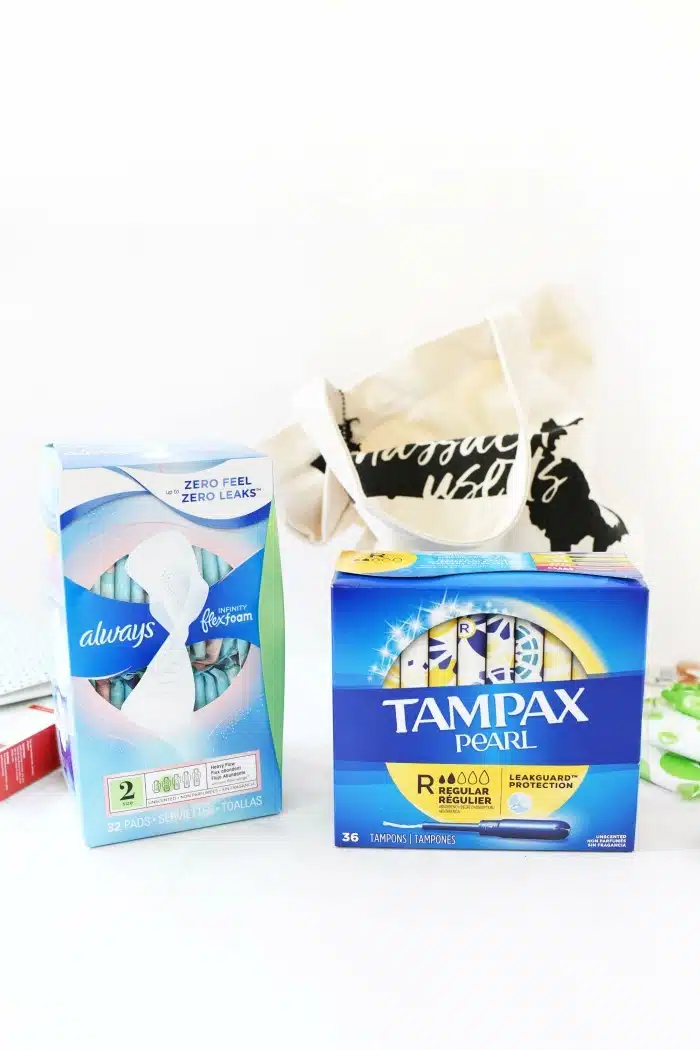 Tampax and Always packages on white table.