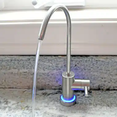reverse osmosis water faucet with water flowing from it