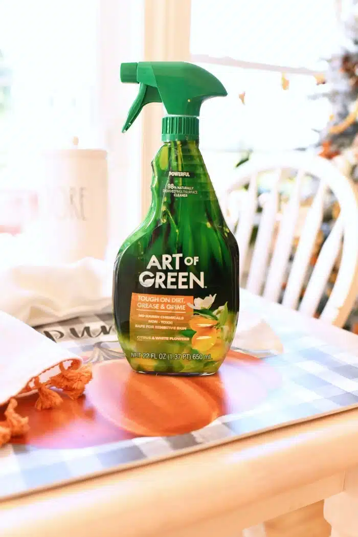 Art of Green Spray bottle on a fall themed table.