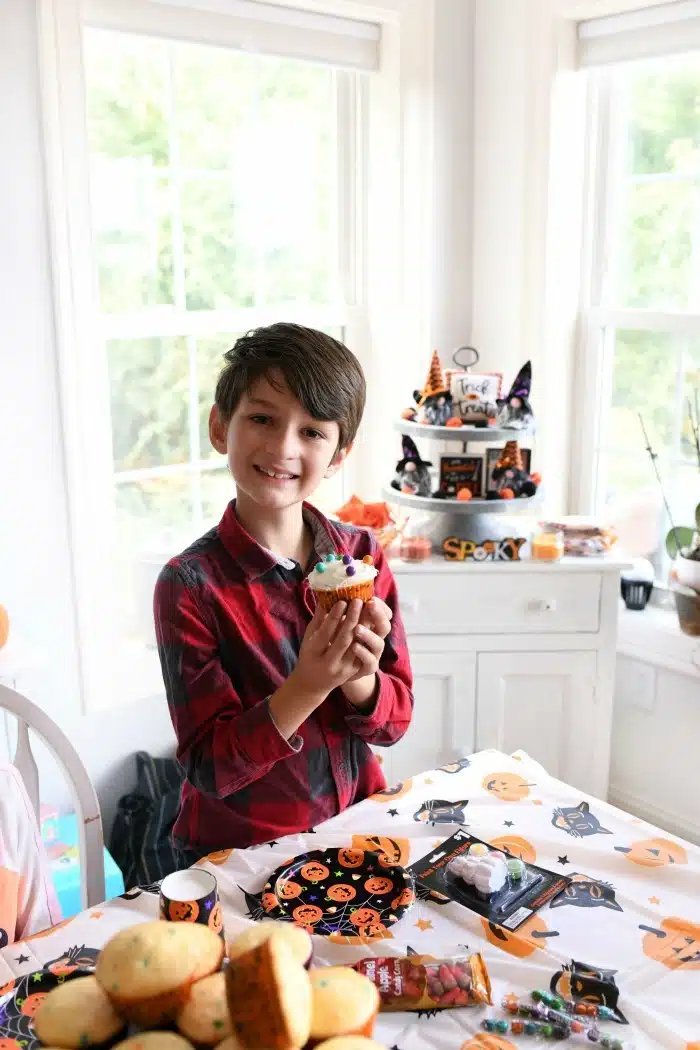 Boy with Halloween cupcake.