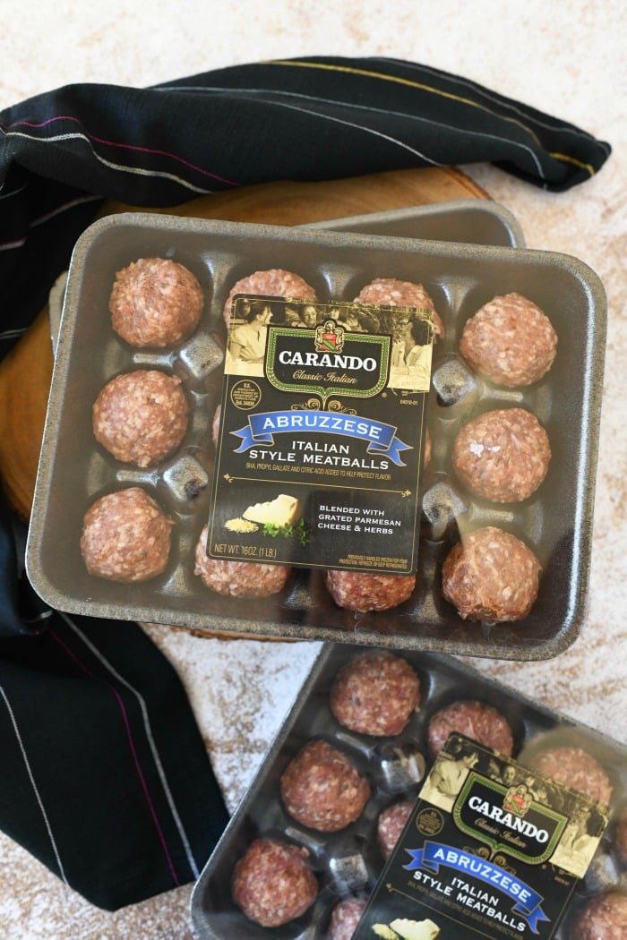 Carando meatballs in a package near a black napkin.