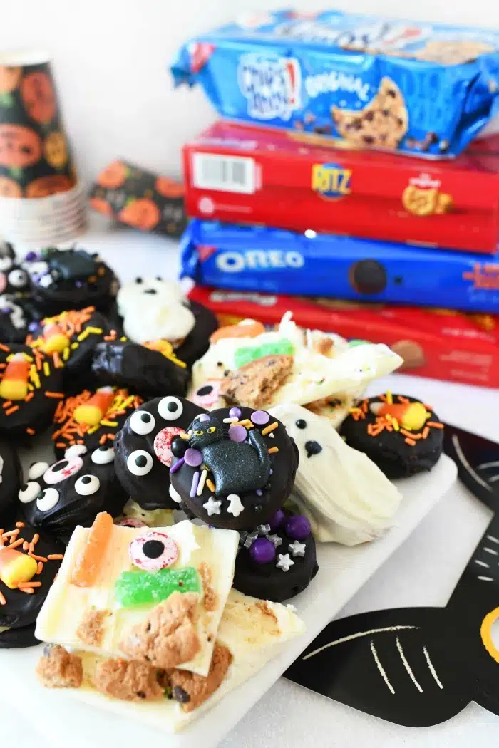 Halloween Cookie Ideas on a white tray with cookie boxes in the background.