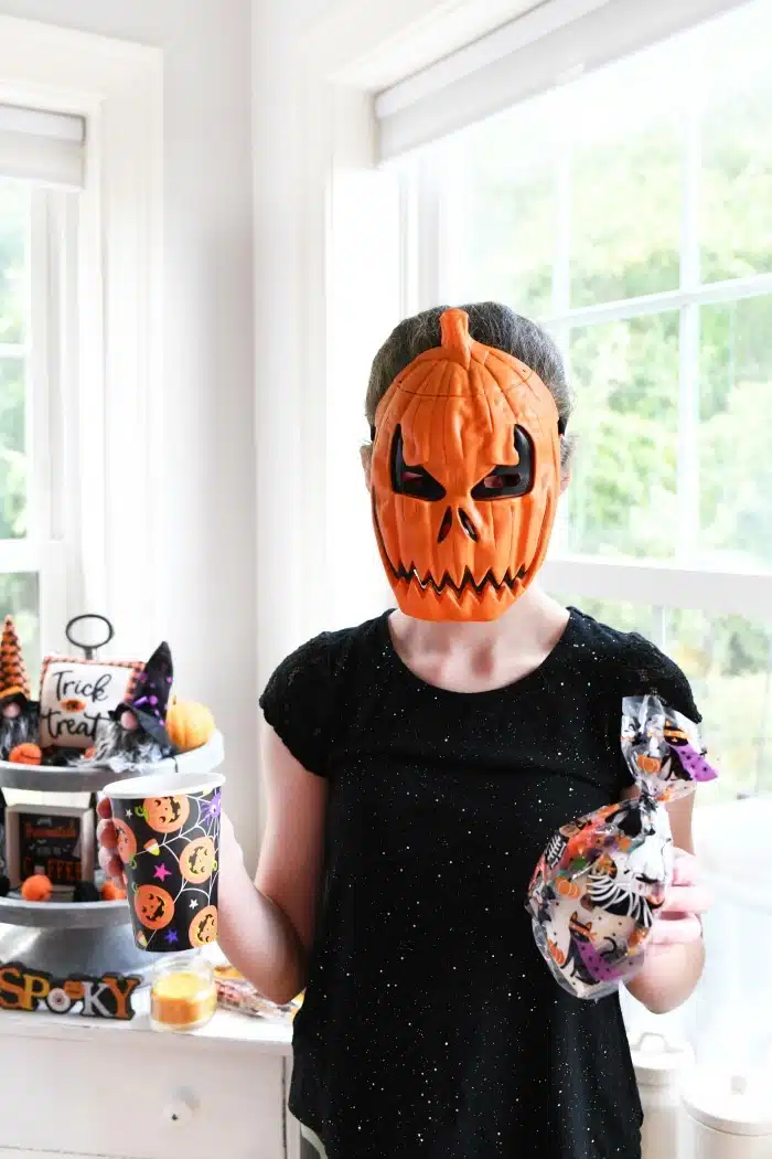 Girl in a Halloween pumpkin mask 