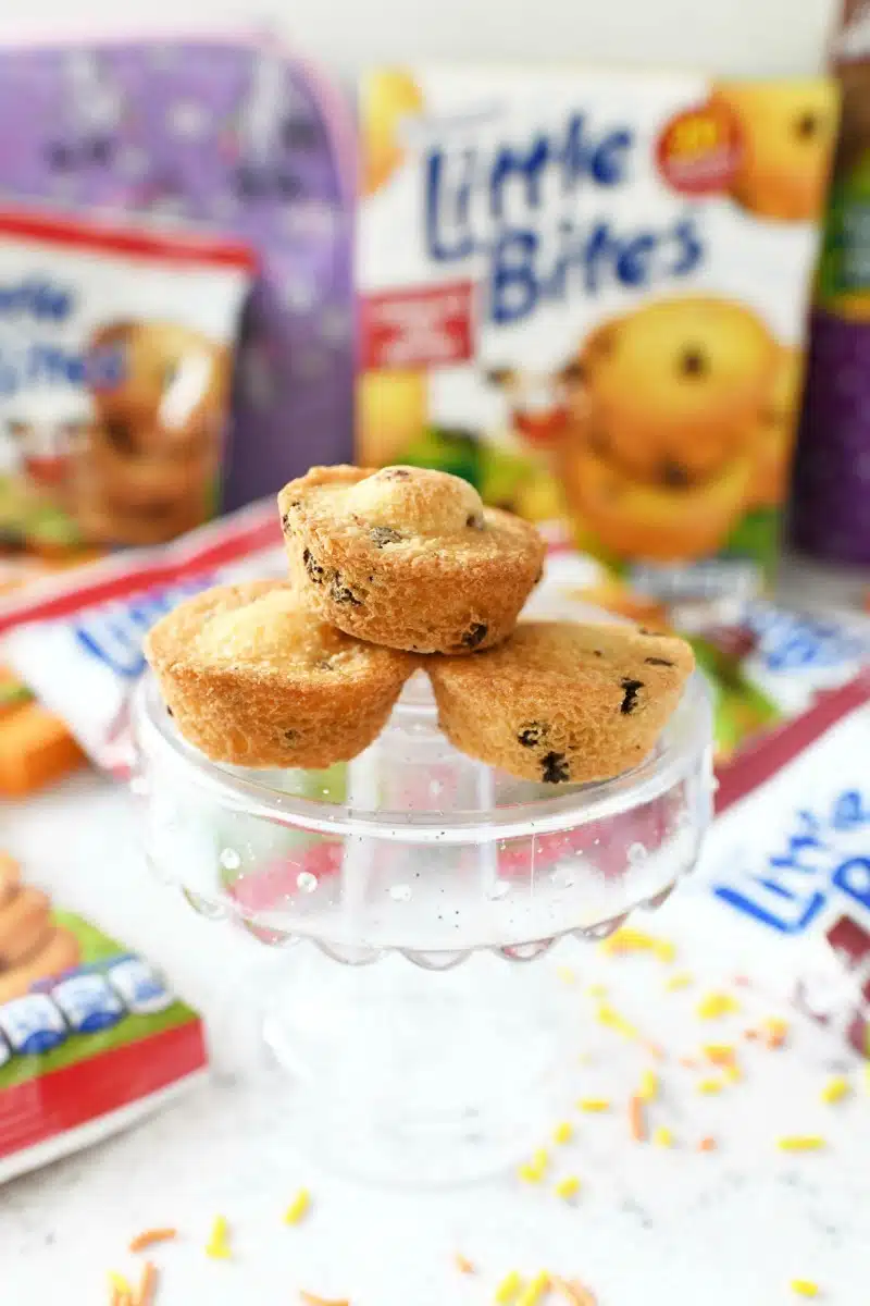 Little Bites chocolate chip muffins on a mini, clear cake stand.