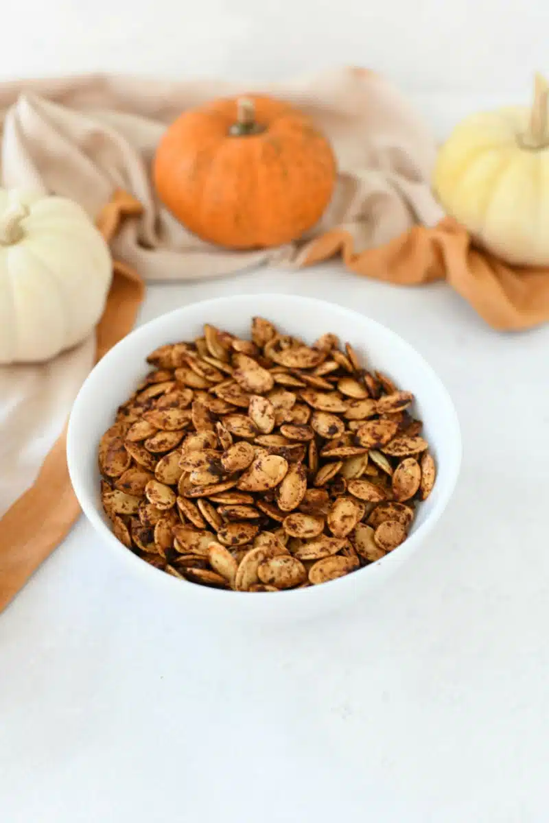 Portuguese Baked Pumpkin Seeds in a white bowl.