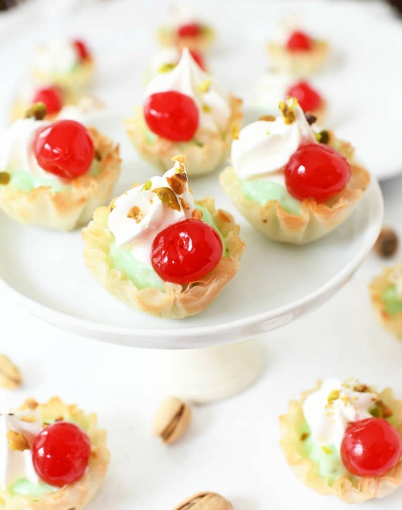 pistachio cherry bites on a white platter.