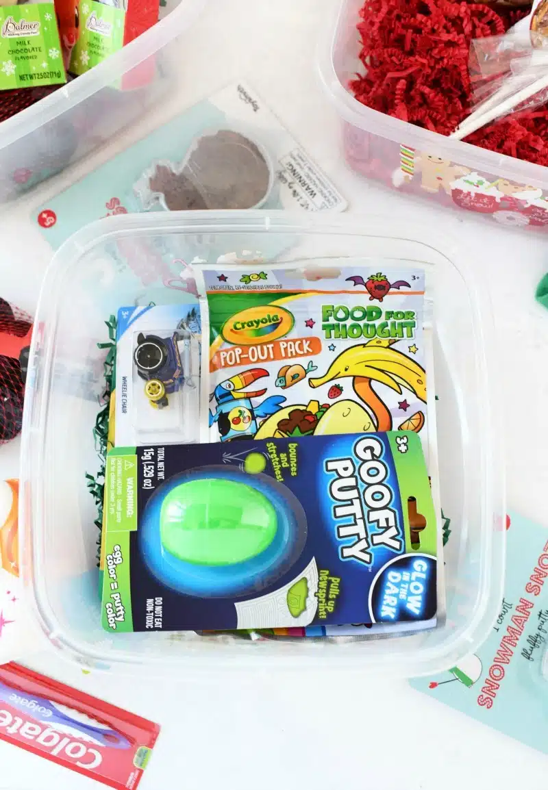 Boy's Christmas Gift Box with toys on a white table. 
