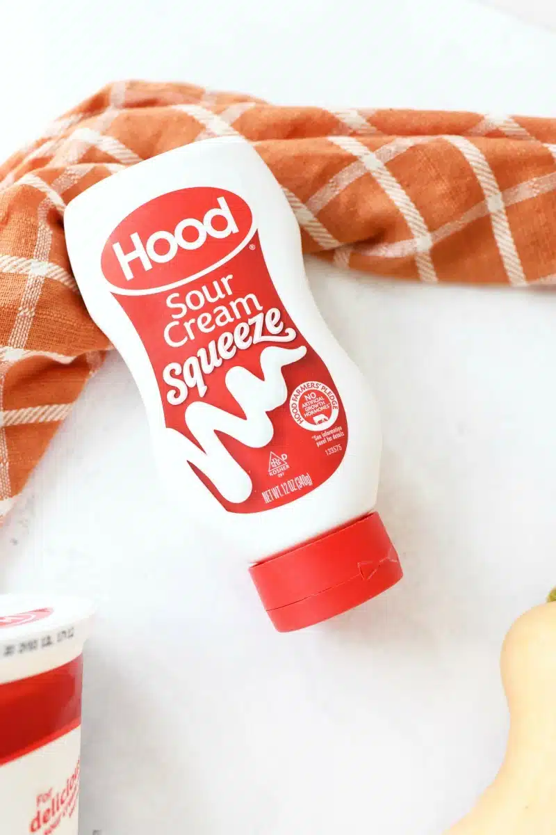 Hood-Squeeze-Sour-cream on a white table with an orange plaid napkin. 