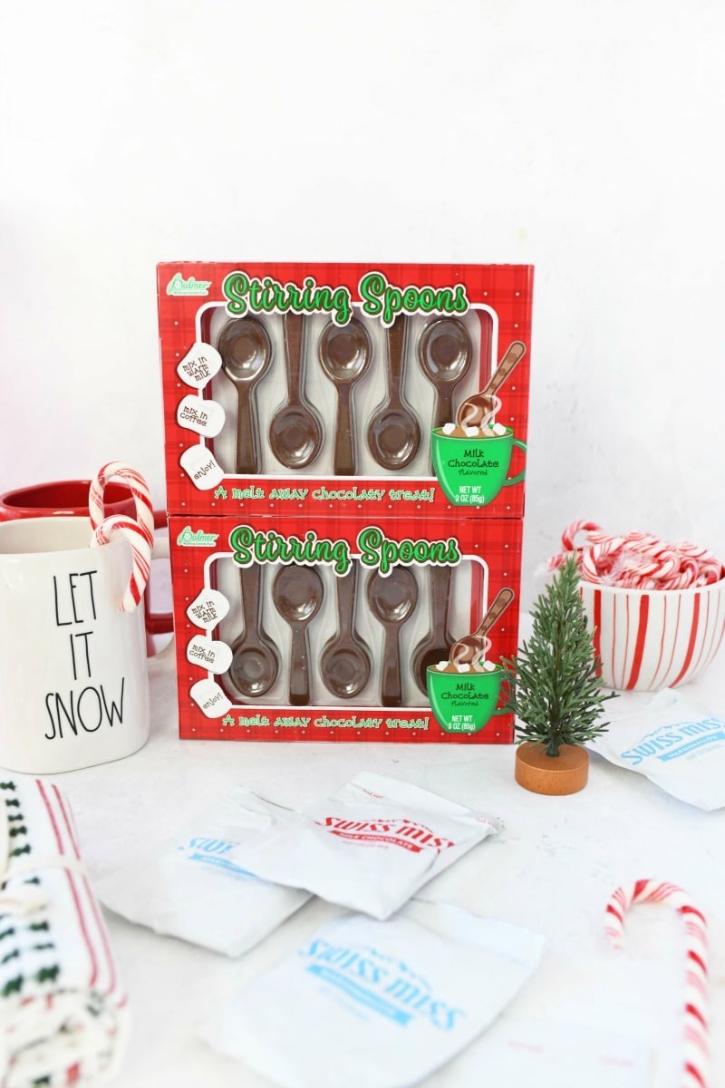 Stirring Spoons gifts with hot cocoa packs on a white table. 