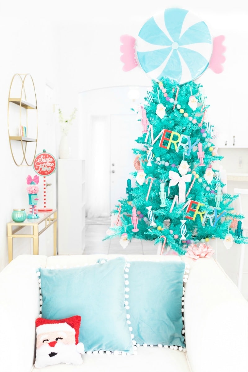 Teal Christmas tree in a white living room.