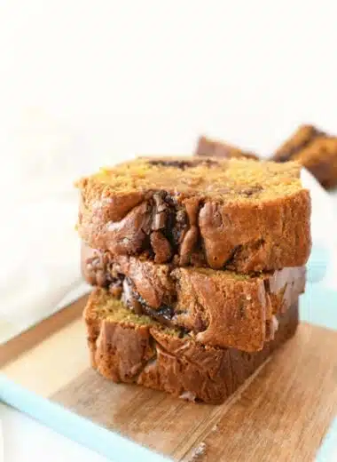 Nutella Pumpkin Bread sliced on a small wooden tray with blue edges.
