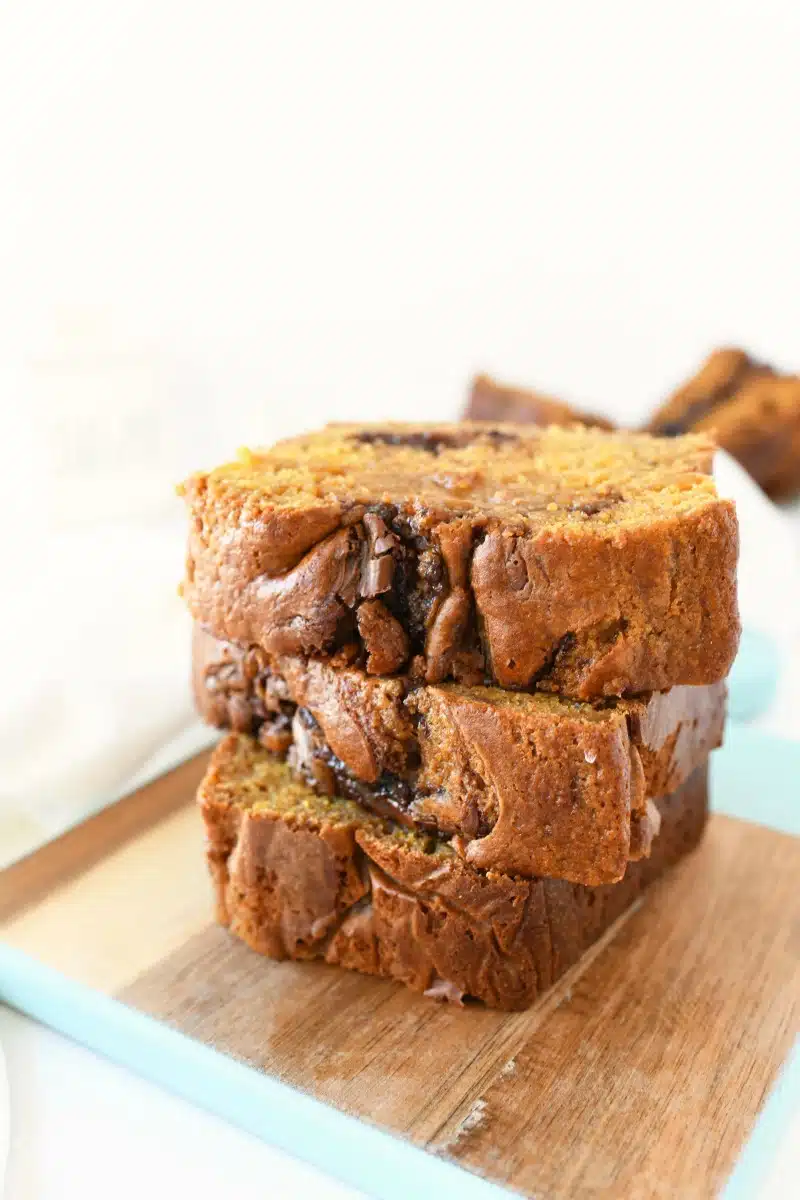 Nutella Pumpkin Bread sliced on a small wooden tray with blue edges. 