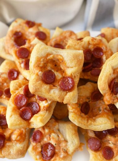 Pepperoni Pizza Dip Bites are stacked on top of each other and baked until a golden brown perfection.