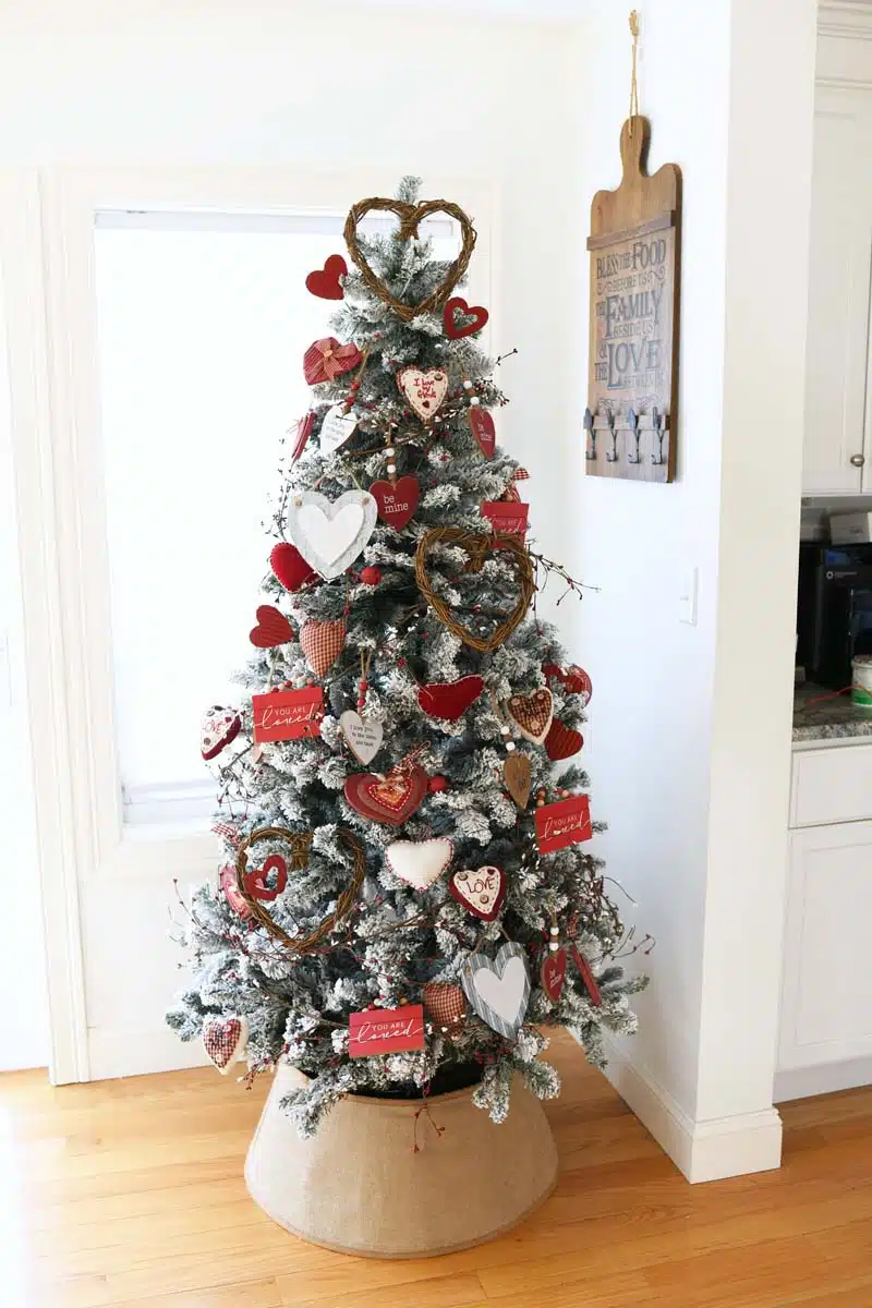 Farmhouse Valentine Tree with a burlap tree collar. There are red and white heart ornaments on this tree.