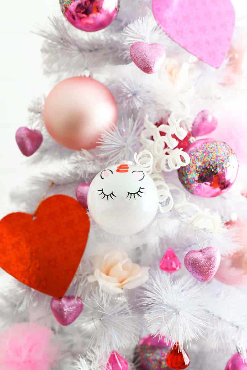 Whimsical Valentines Day Tree up close with pink and red ornaments. 