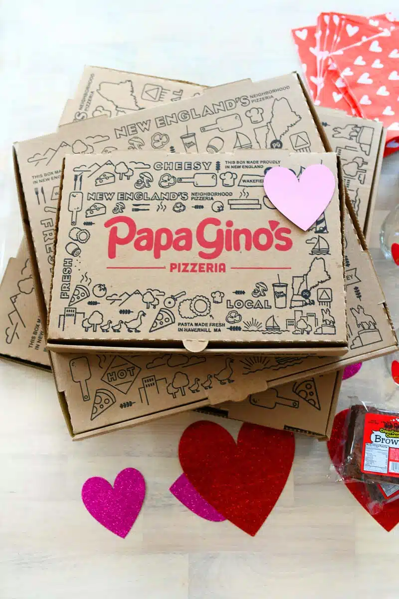 Papa Ginos Boxes with red and purple hearts on them. There is also a pint of Ben & Jerry's in this shot.