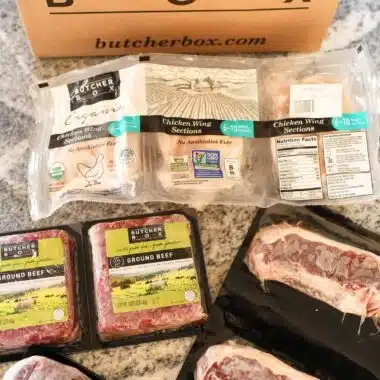 Butcher Box Beef Box ona counter with frozen cuts of meat nearby.