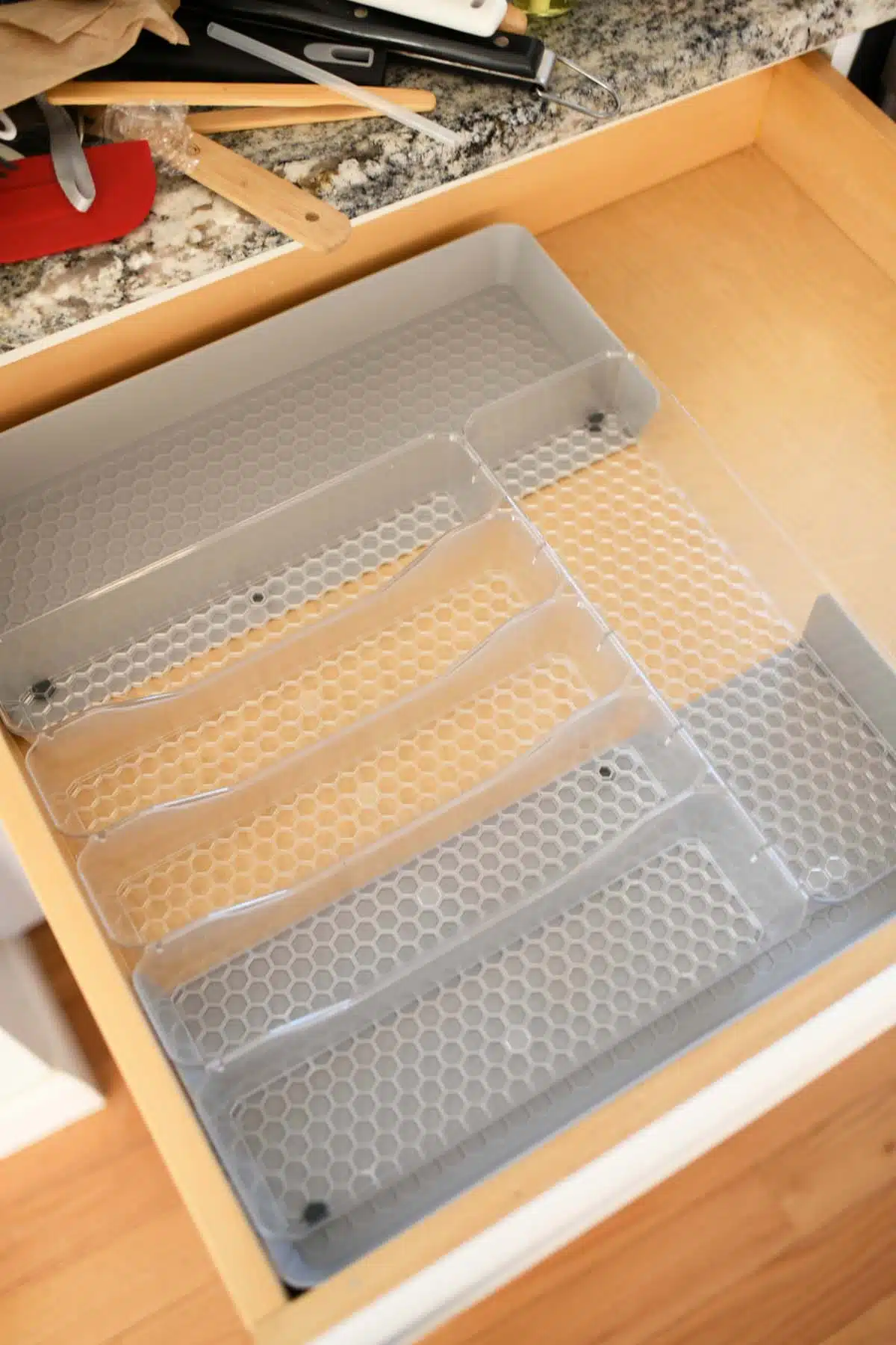 Hexa By Spectrum Expandable Drawer Organizer. Item is inside a drawer, expanded. 