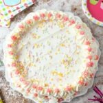 Strawberry Vanilla Ice Cream Cake on a speckled wood table.