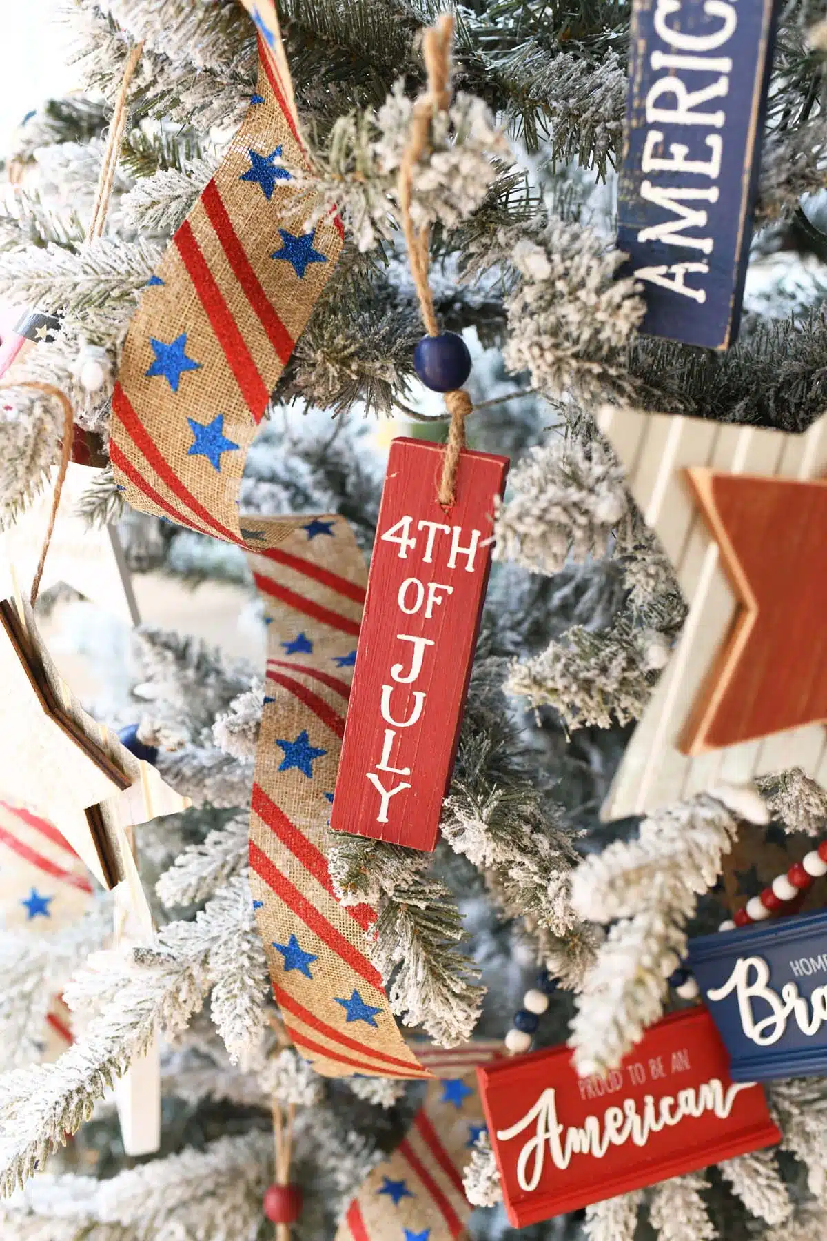 Red block 4th of July Ornament on a tree.