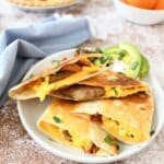 Breakfast Grilled Wrap on a white plate with a blue napkin.
