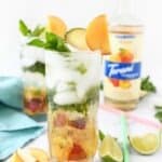 Peachy mint mojito in a tall glass.