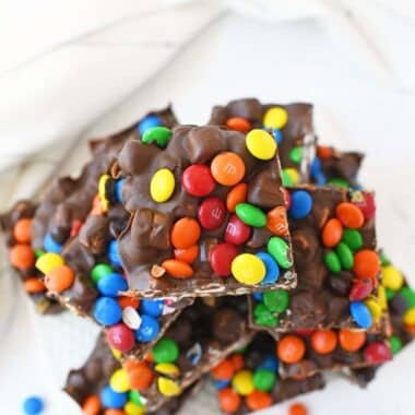 Marshmallow Dream Bars with M&Ms on a white tray.