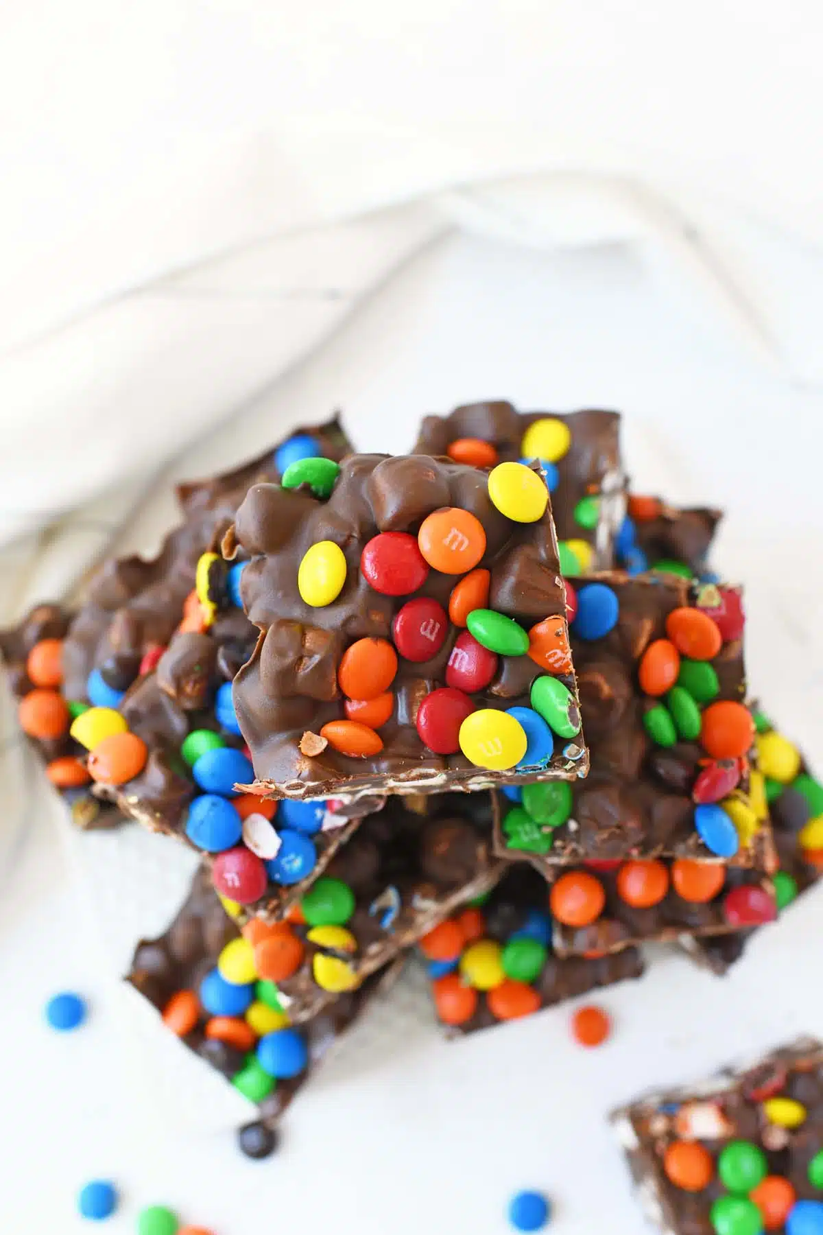 Marshmallow Dream Bars with M&Ms on a white tray.