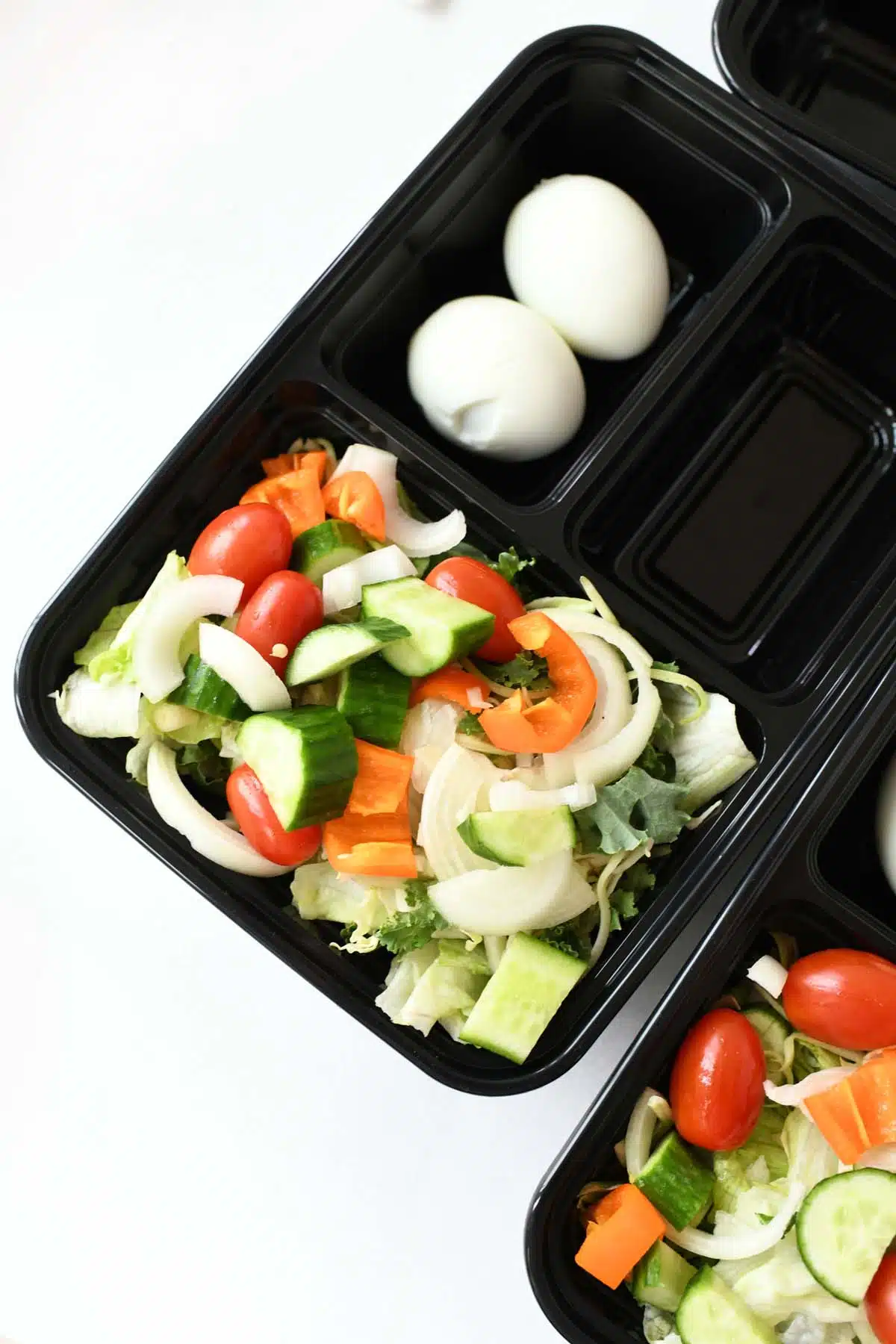 A garden salad in a meal prep container.