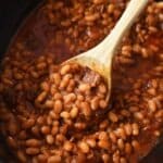 A wooden spoon nestled inside Boston Baked Beans.