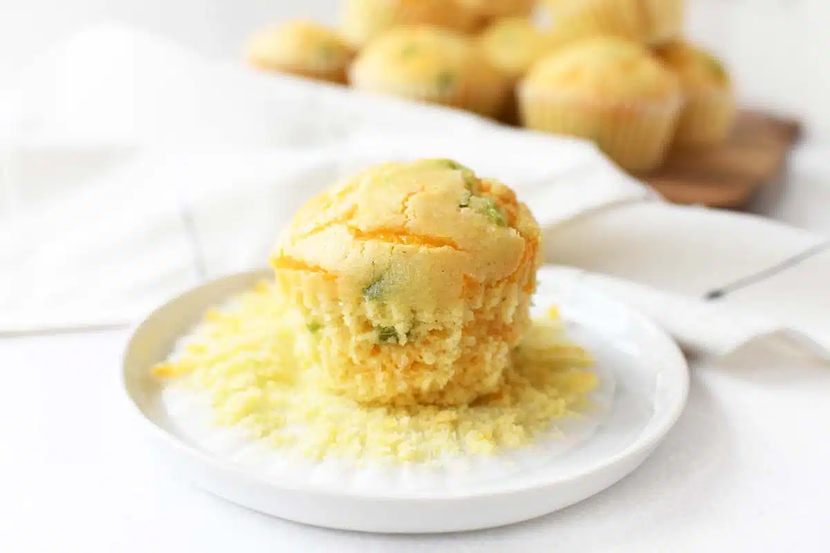 A jalapeno cheddar corn muffin on a white plate.