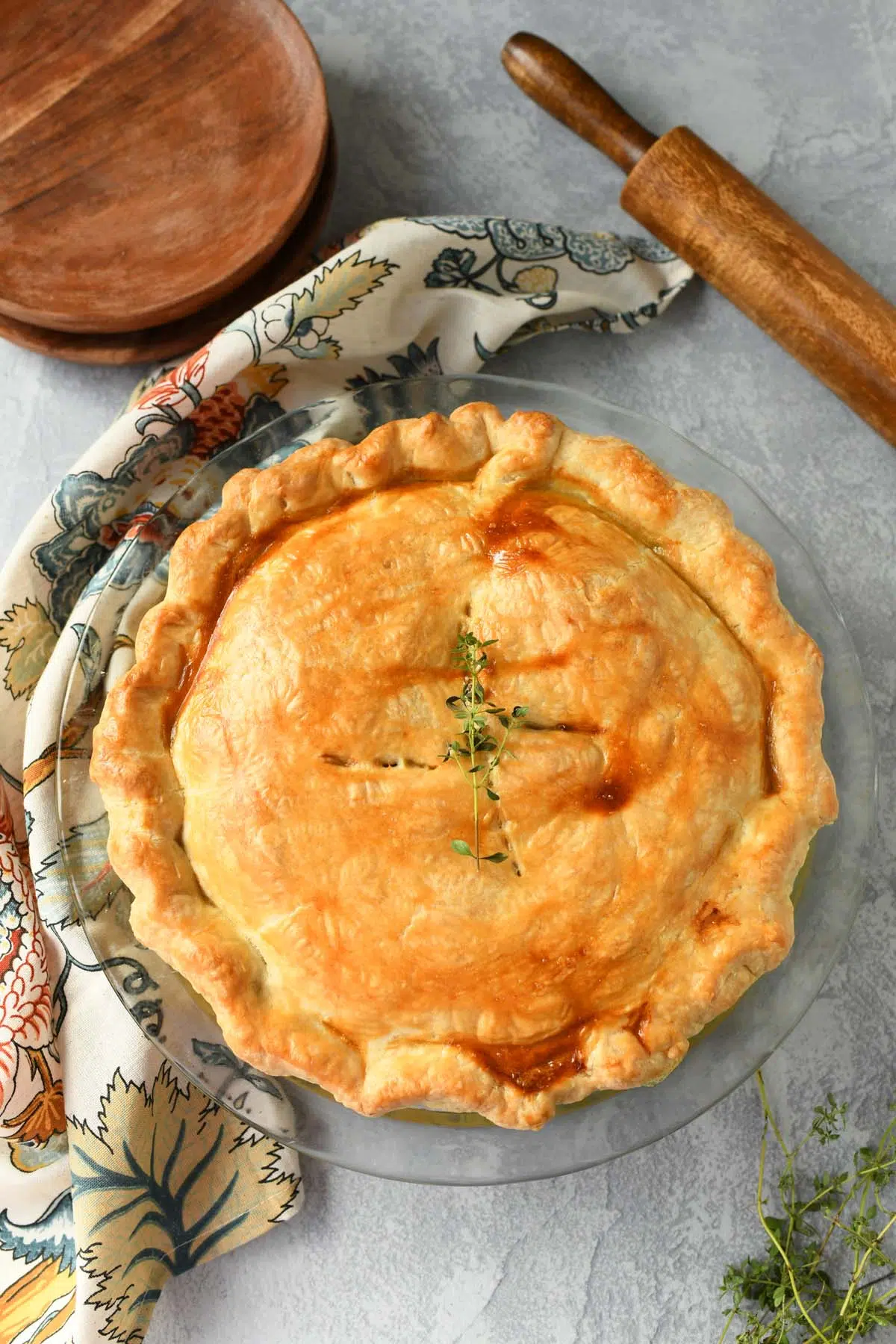 Golden-brown chicken pot pie on a grey surface.