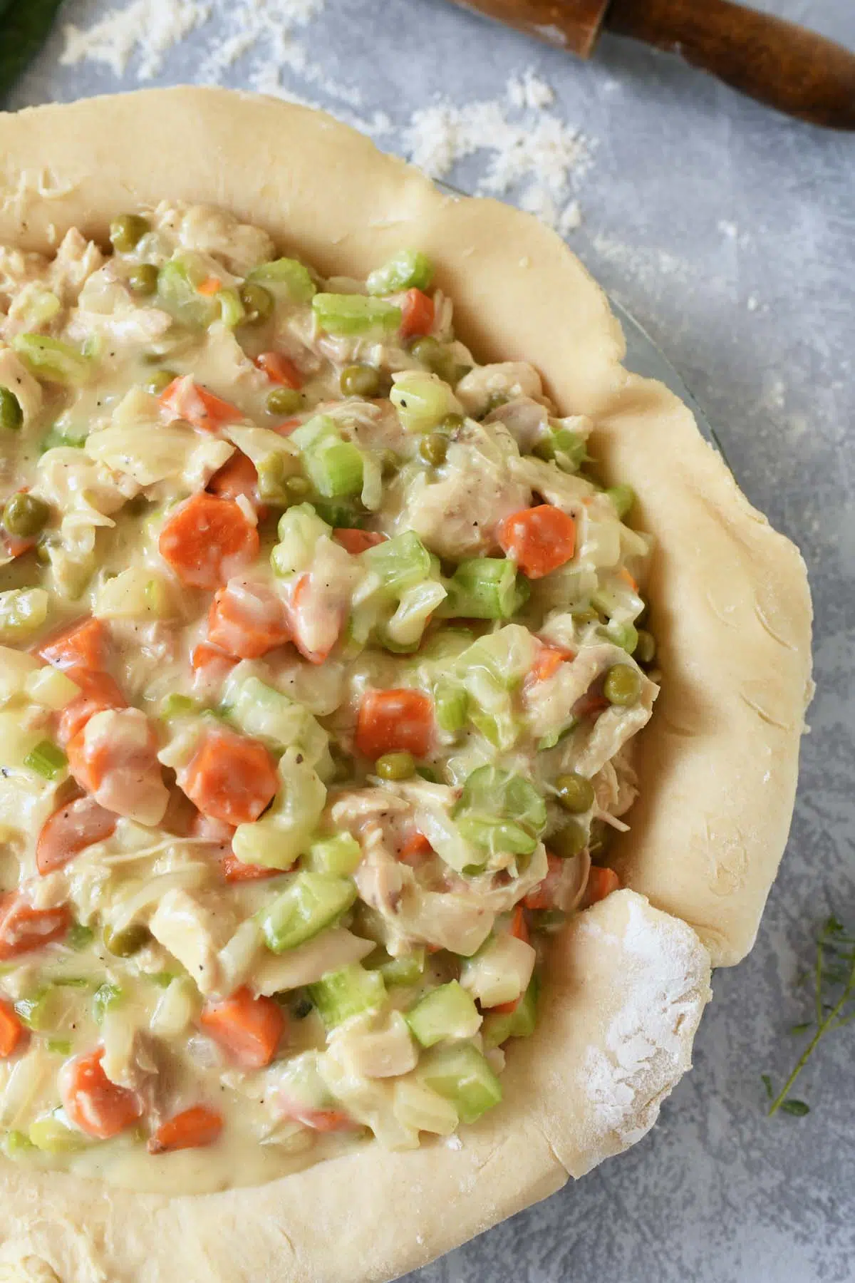 Chicken pot pie filling in an unbaked pie crust.