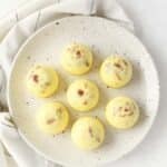Bacon gruyere egg bites on a white plate.