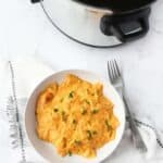 Slow Cooker Feta and Tomato Pasta on a white plate with a silver fork.