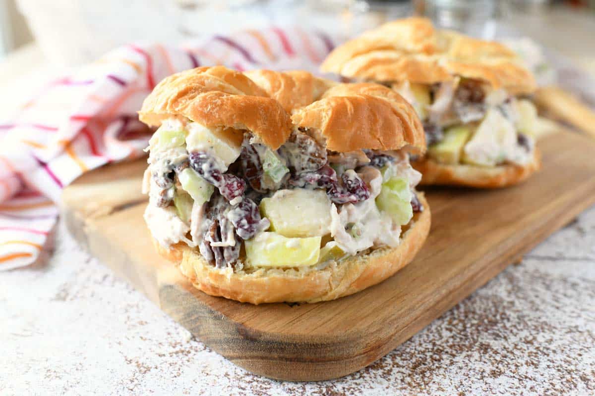 Chicken salad with apples and cranberries on a golden croissant.