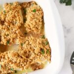 New England Baked cod in a white baking dish.