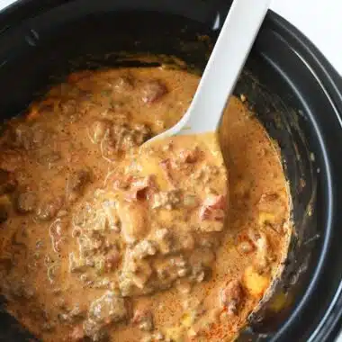 Cheesy Slow Cooker Taco Dip with a grey spoon.